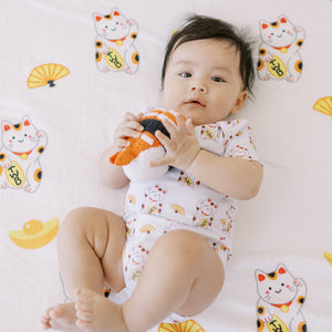 cute baby lying down in the wee bean organic cotton baby onesie bodysuit romper in lucky fortune cat