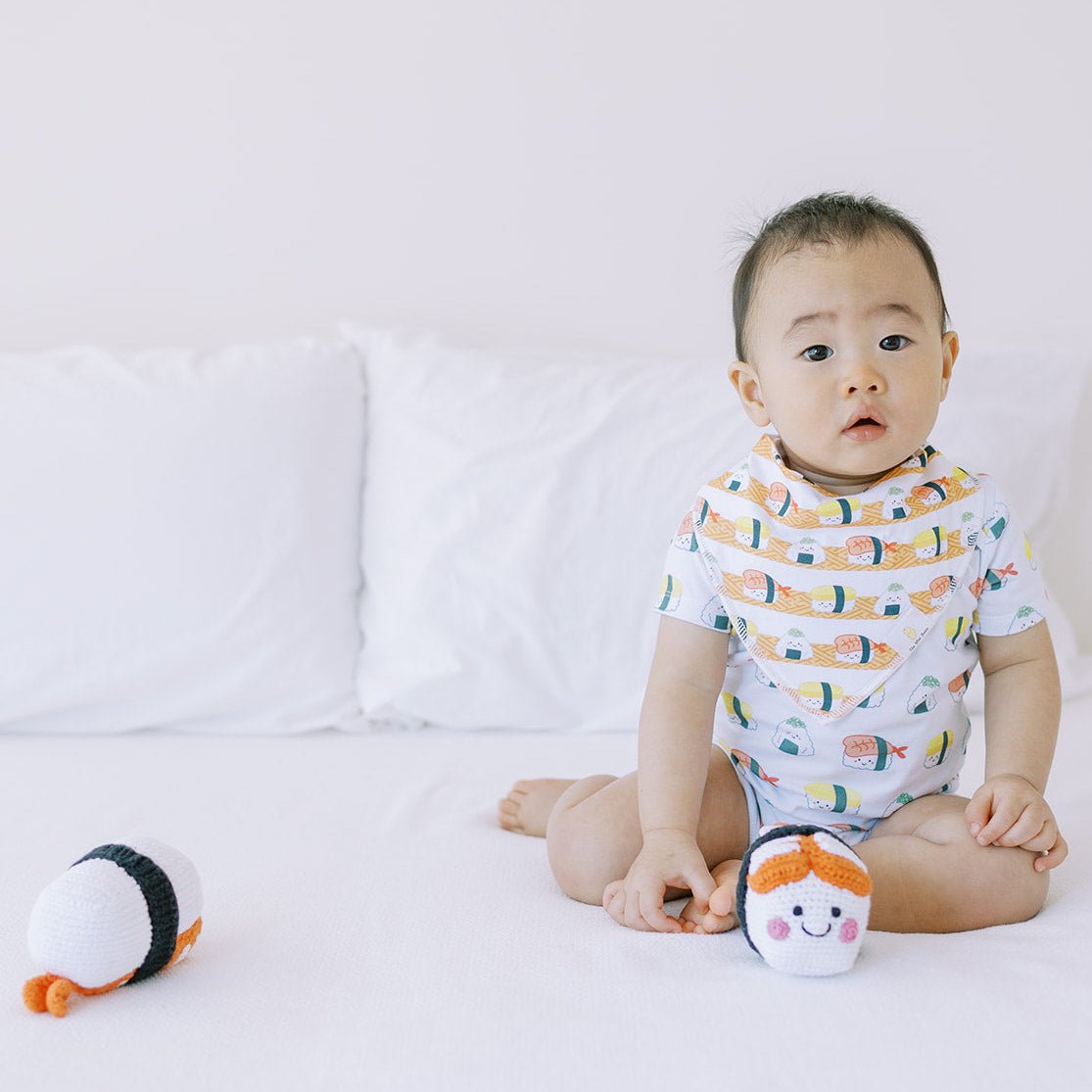 cute baby wearing taste of japan baby onesie and organic cotton bib