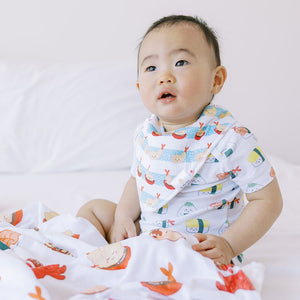 cute baby wearing the wee bean organic cotton baby bandana bibs in shrimp tempura from taste of japan collection