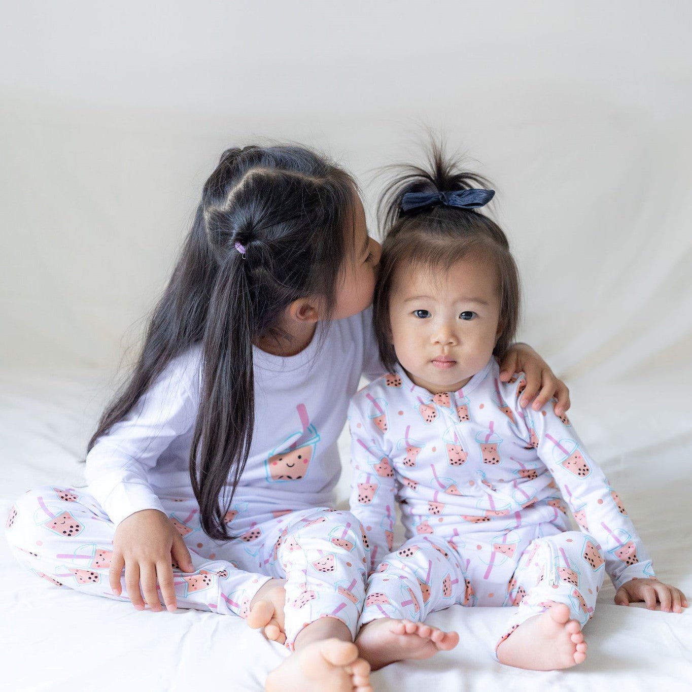 cute child smiling in the wee bean boba bae bamboo sleepwear siblings