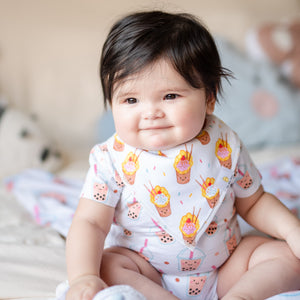 cute baby smiling in organic cotton bandana bib in egg waffle ice cream sundae