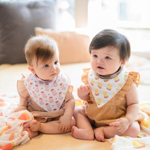 two babies wearing the wee bean organic cotton bib set in yakult and vita lemon iced tea